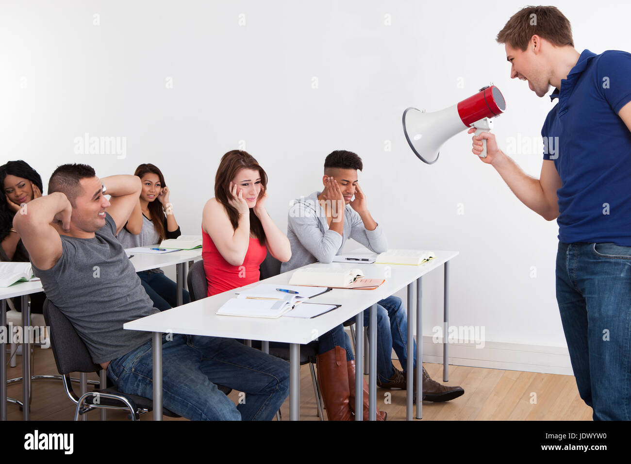 Angry teacher shouting through megaphone on university students in