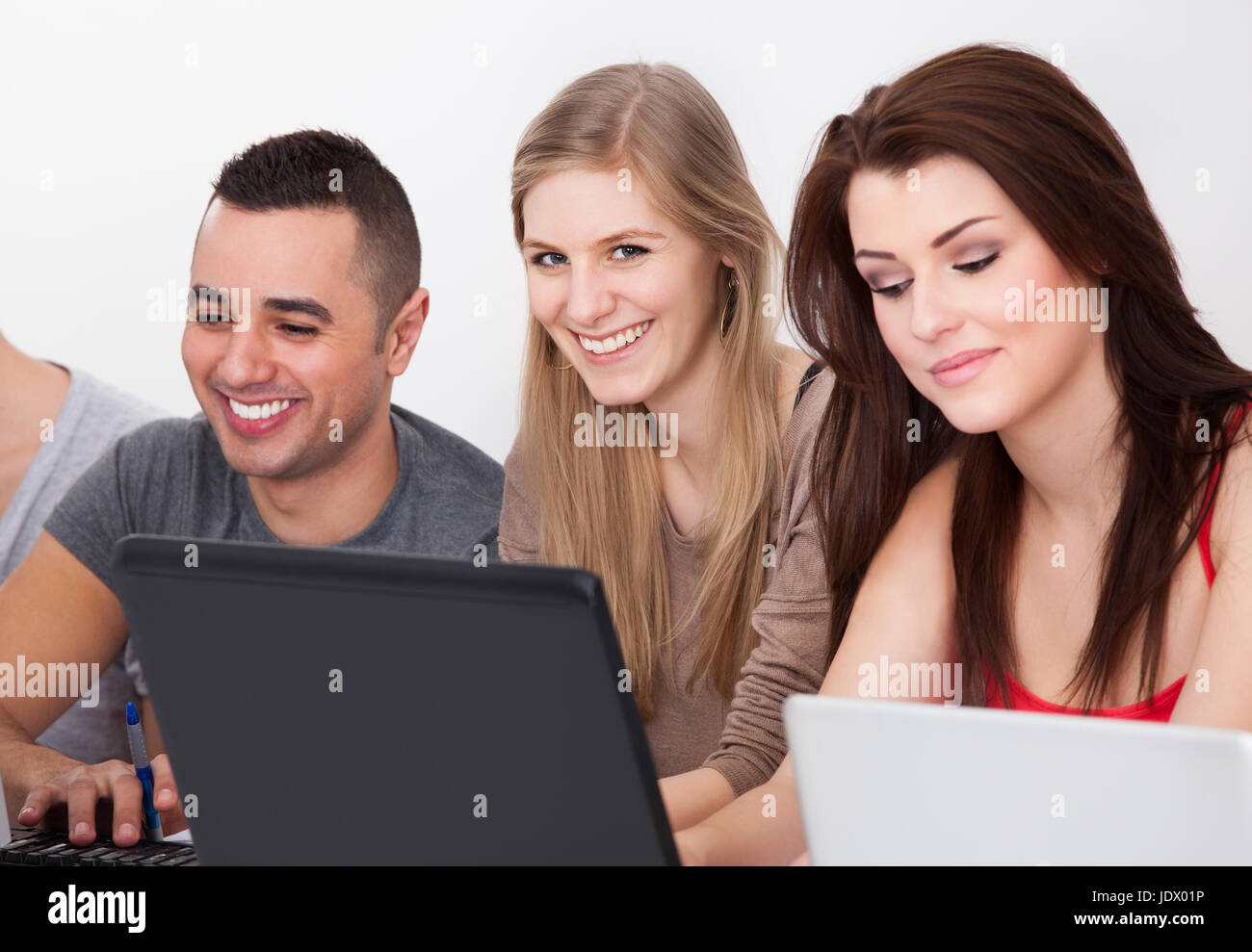 Portrait of confident male college student with classmates in computer ...