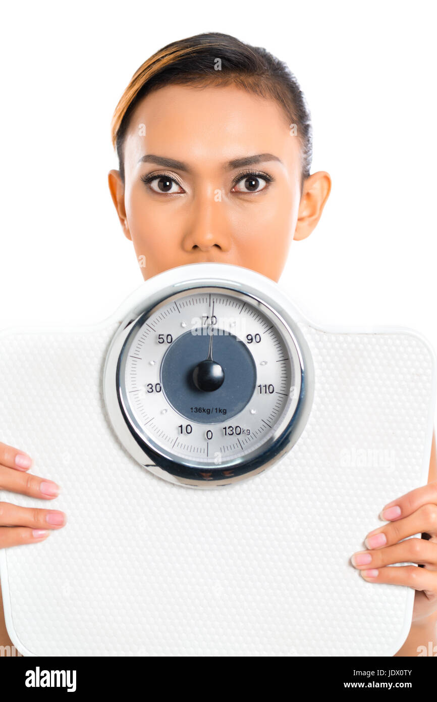 Asian woman with weight scale loosing weight Stock Photo