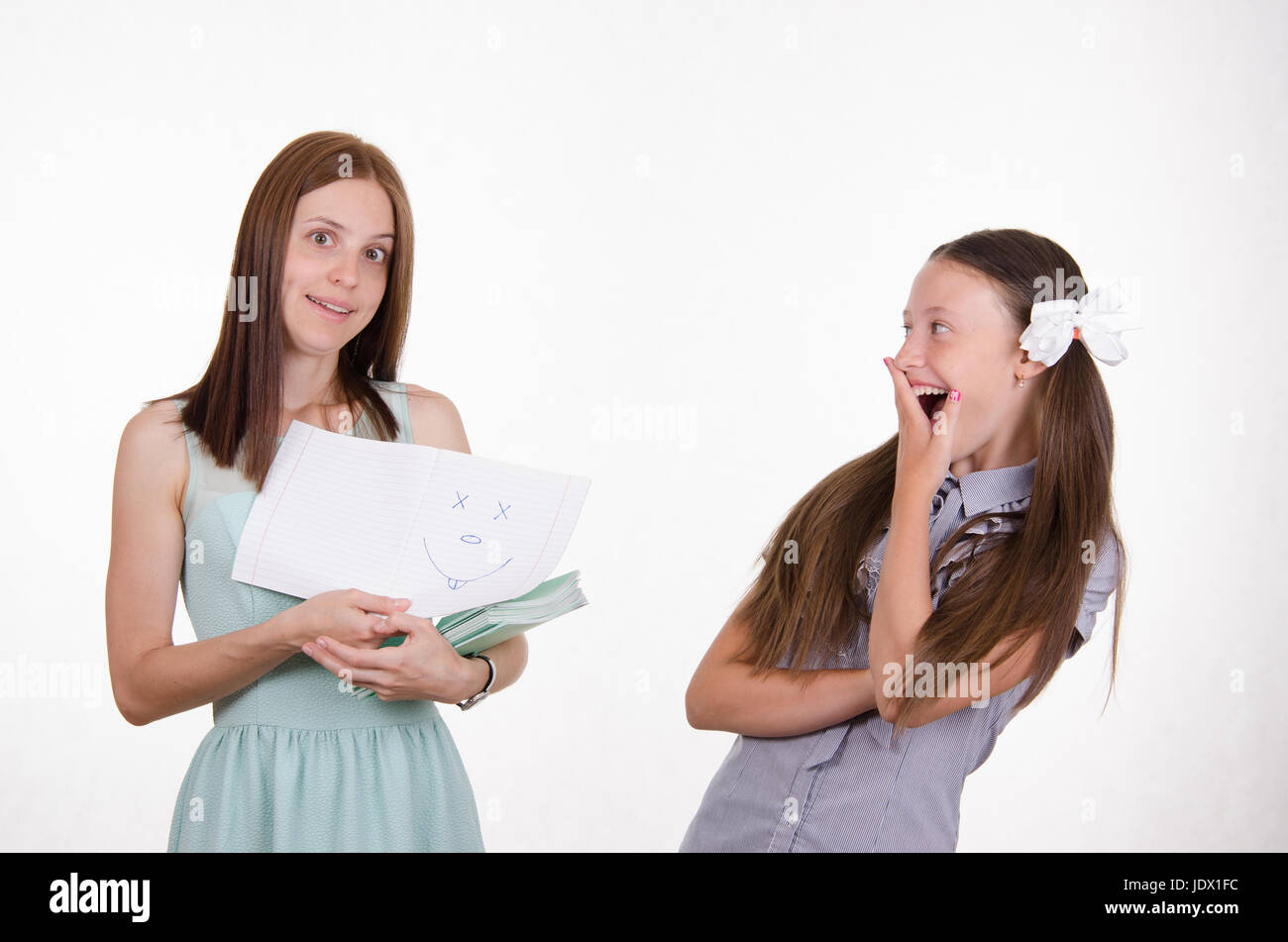 Teacher checking notebooks students saw one of them funny painted a ...