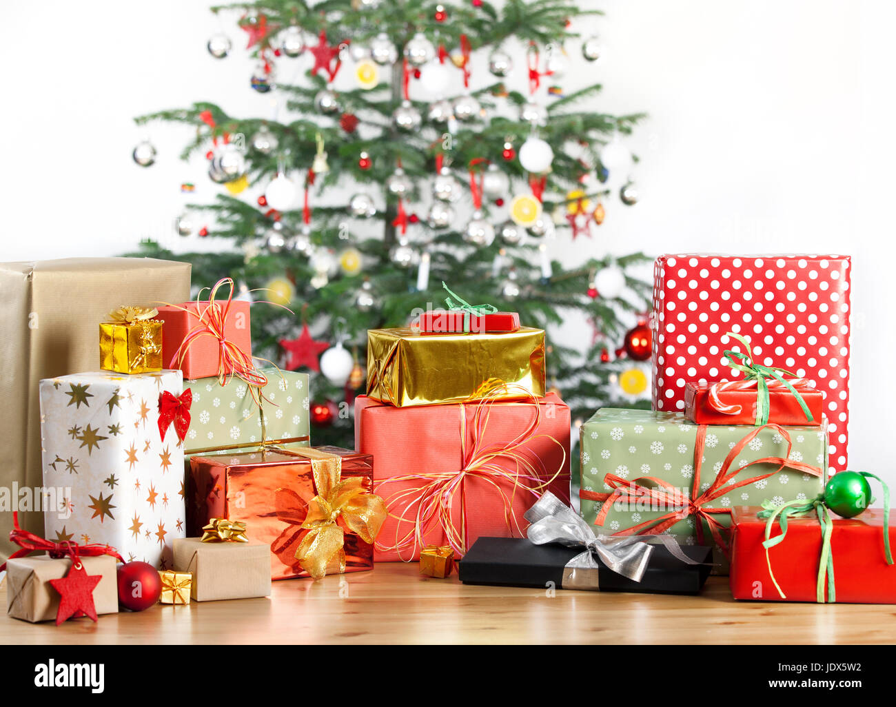 christmas tree in the background with lots of gifts Stock Photo Alamy