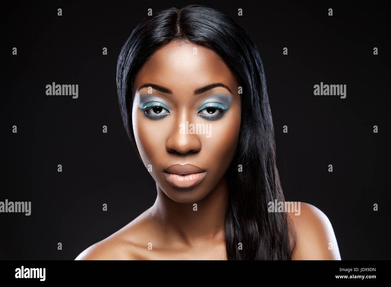 Beautiful young black woman with makeup and long hair Stock Photo - Alamy