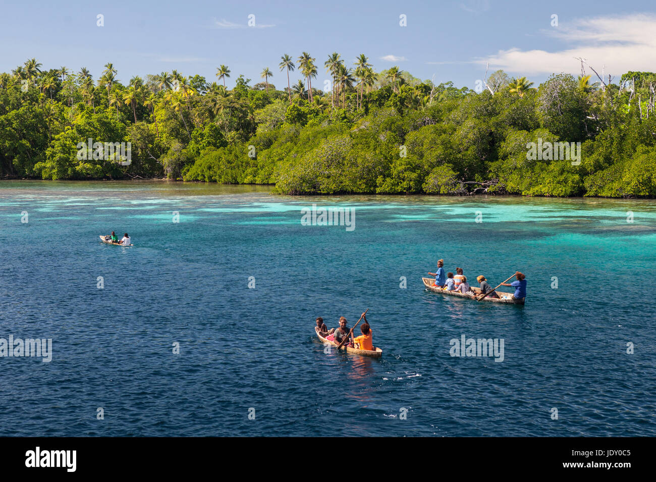 Natives paddling in canoe, Melanesia, Pacific Ocean, Solomon Islands Stock Photo