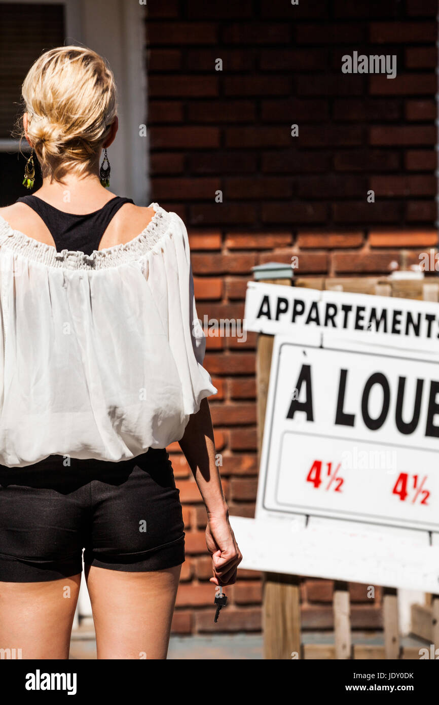 Young Woman standing with keys in front of her new apartment Stock ...
