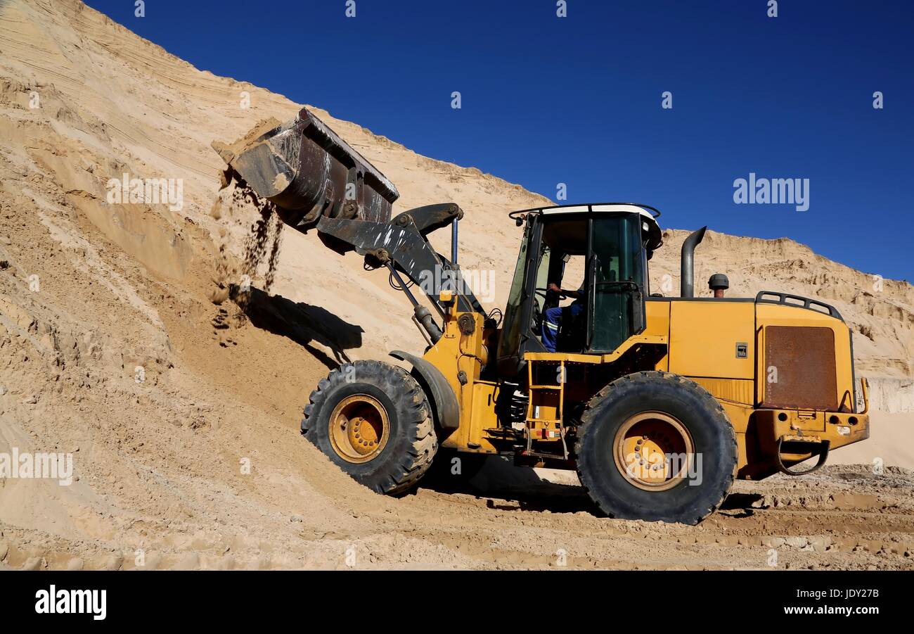 Front end loader machine digging up sand Stock Photo Alamy
