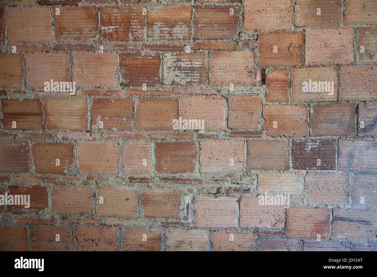 Abstract reddish bricks background gritty texture. Stock Photo
