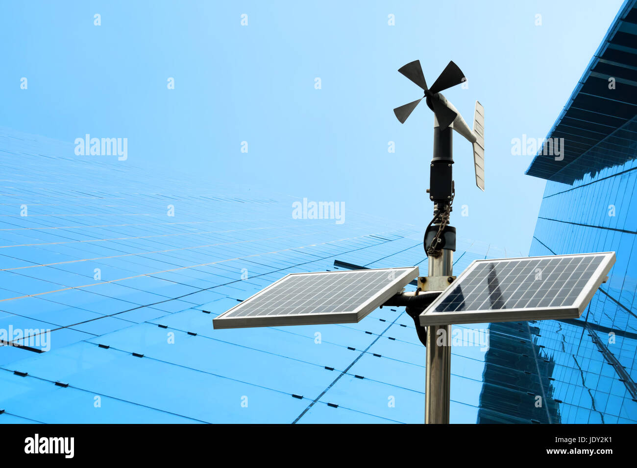 Revolving vane anemometer, a meteorological instrument used to measure the wind speed and solar cell system technology with blue building background i Stock Photo