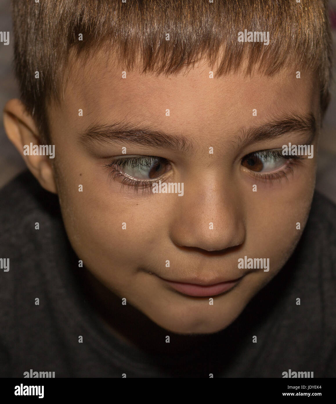 Portrait of a cute little boy with crossed eyes smiling Stock Photo Alamy