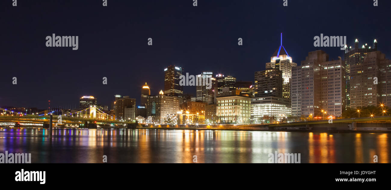 Pittsburgh, Pennsylvania skyline at night overlooking the Allegheny River with the Andy Warhol Bridge and Roberto Clemente Bridge in background. Stock Photo