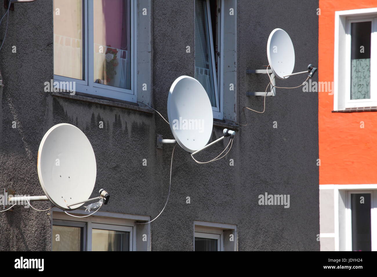 satellite bowls on a house wall Stock Photo Alamy