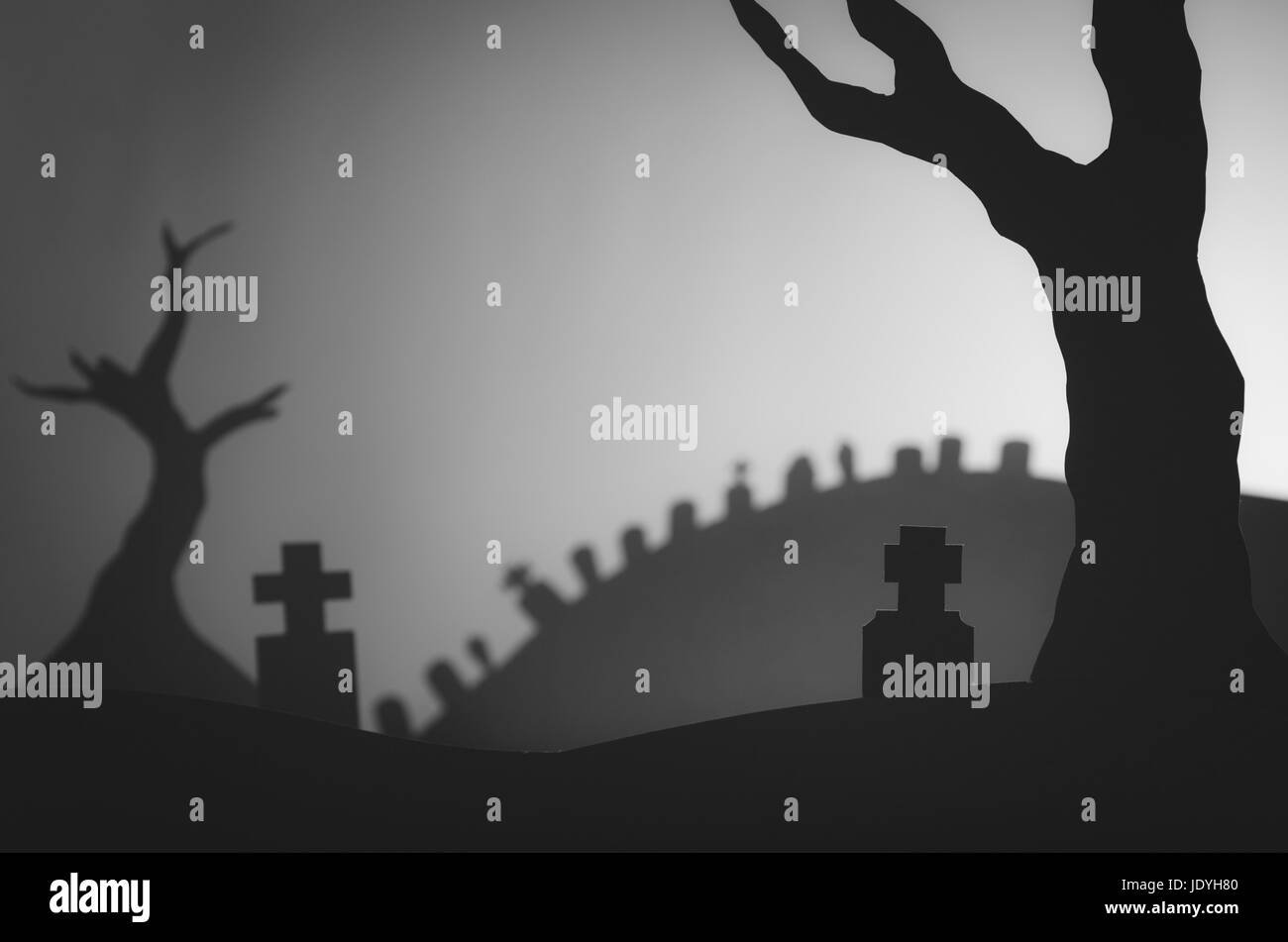 dark Halloween landscape with tombstones and trees, creative graveyard paper cutout Stock Photo