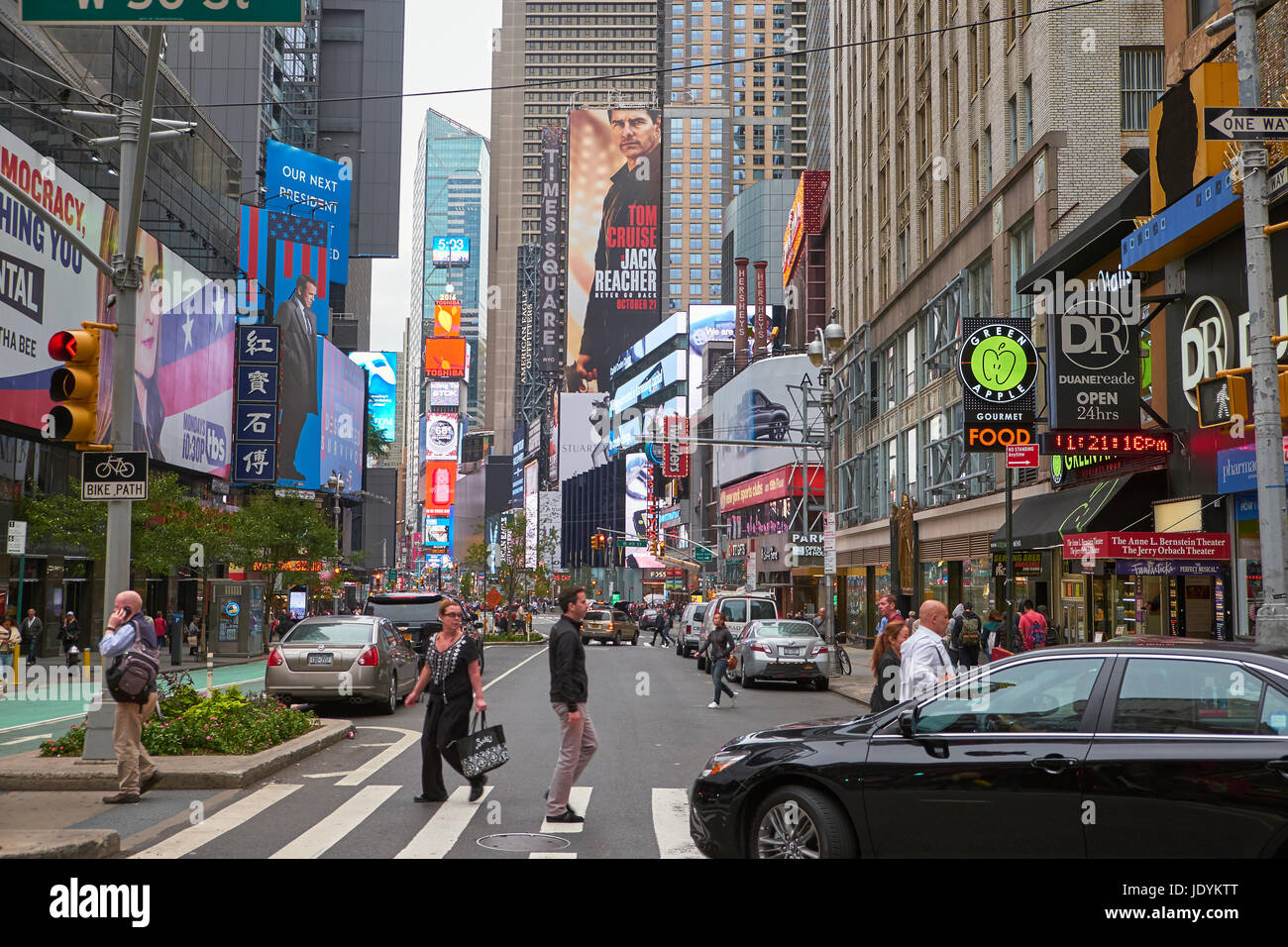 NEW YORK CITY - SEPTEMBER 29, 2016: Look down Broadway with billboards and people crossing the street in the foreground Stock Photo