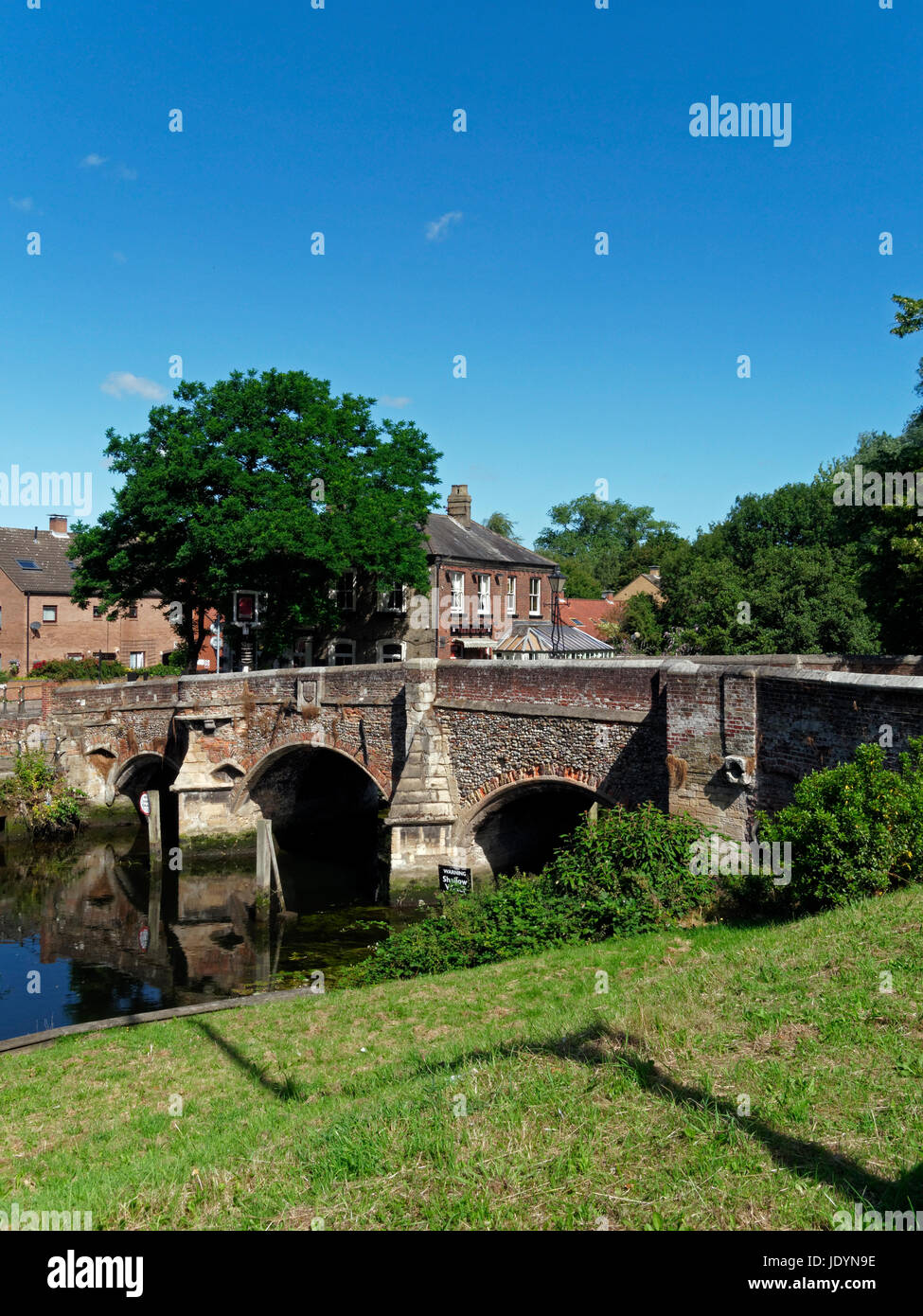 The Ancient, 14th Century, Bishop Bridge, spanning The River Wensum in Norwich, Norfolk, England, UK Stock Photo