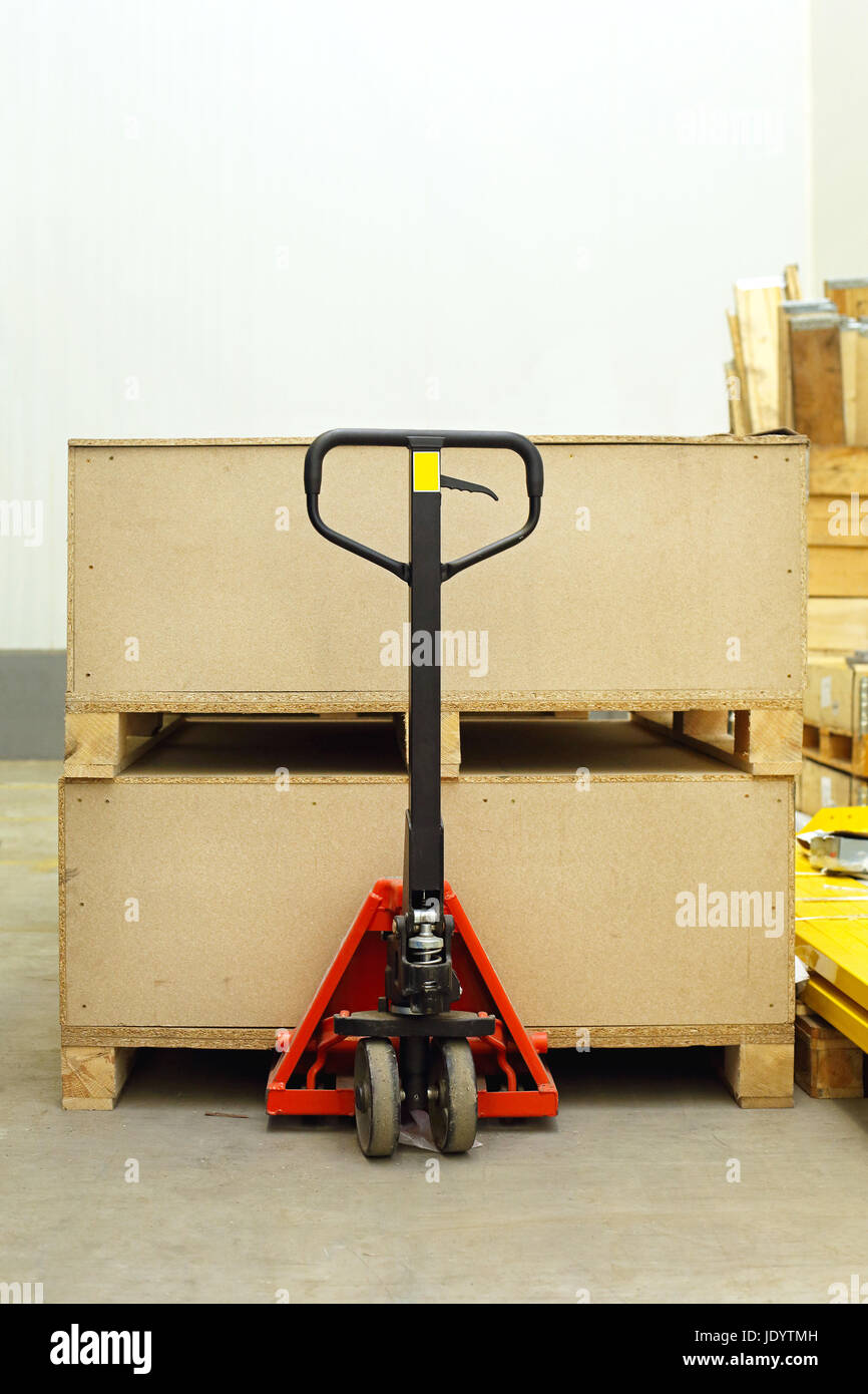 Pallet jack with big wooden crates boxes Stock Photo Alamy