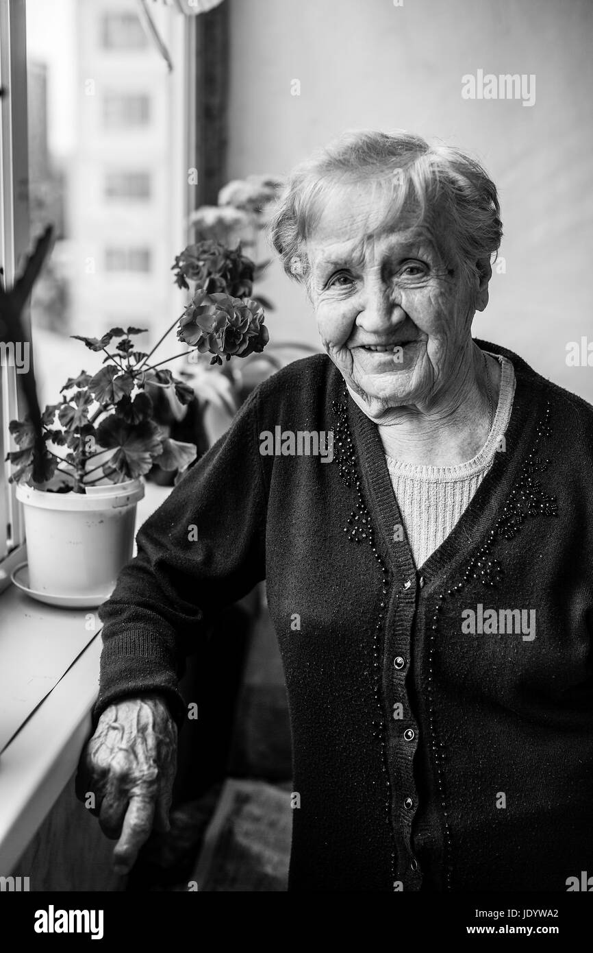 Portrait of an elderly woman on the balcony, black and white photo ...