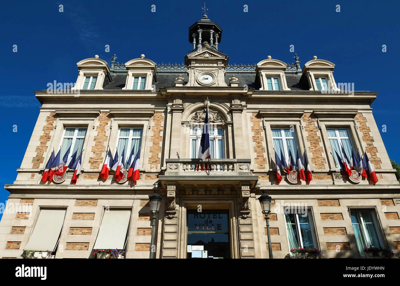 The city hall of Maisons Laffitte town decorated with national French flags, parisian region, France. Stock Photo
