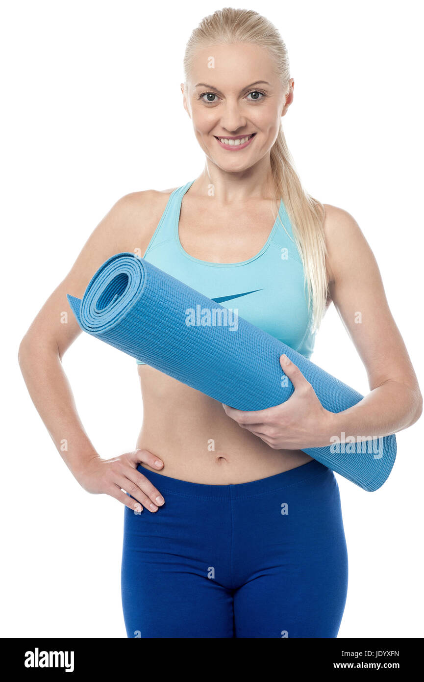 Young fitness woman holding exercise mat Stock Photo - Alamy
