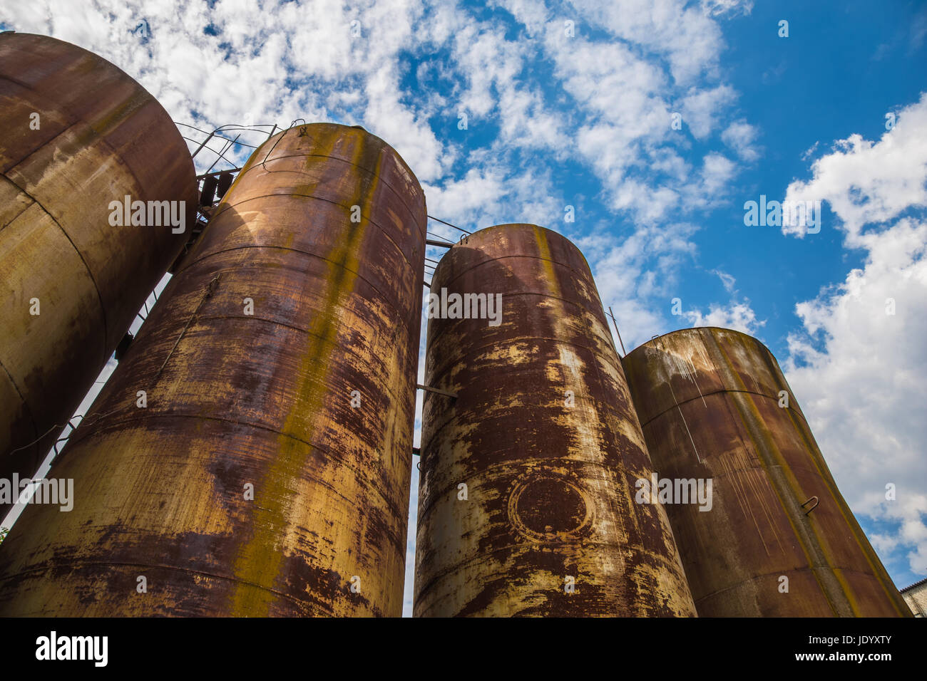 Big old deserted rusty tanks Stock Photo - Alamy