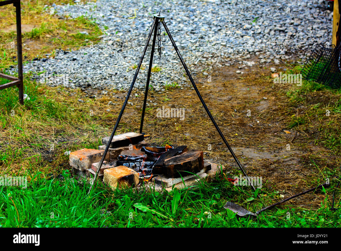 Cooking on a fire in the open air, fire, stand on three supports under the pot Stock Photo