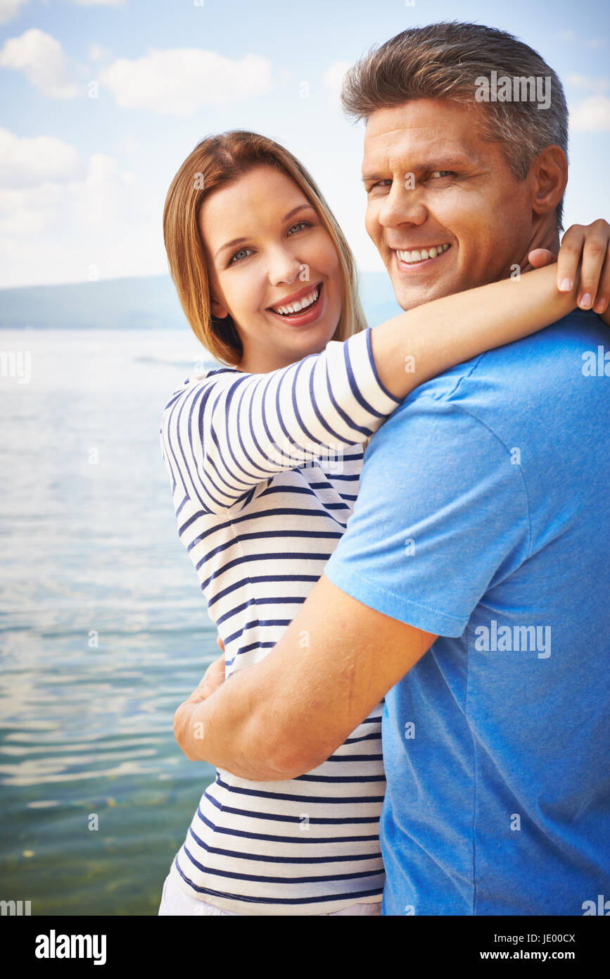 Couple embracing near water Stock Photo Alamy