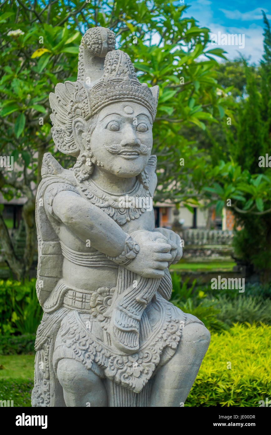 BALI, INDONESIA - MARCH 08, 2017: Beautiful stone statue inside of the Royal temple of Mengwi Empire located in Mengwi in Bali, Indonesia. Stock Photo