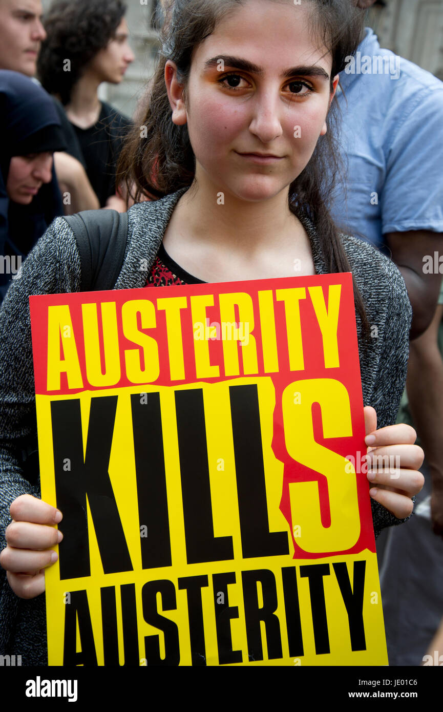 London, UK. 21st June, 2017. Day of rage protest after the fire at Grenfell House, West London. A woman holds a placard which says 'Austerity kills'. Credit: Jenny Matthews/Alamy Live News Stock Photo