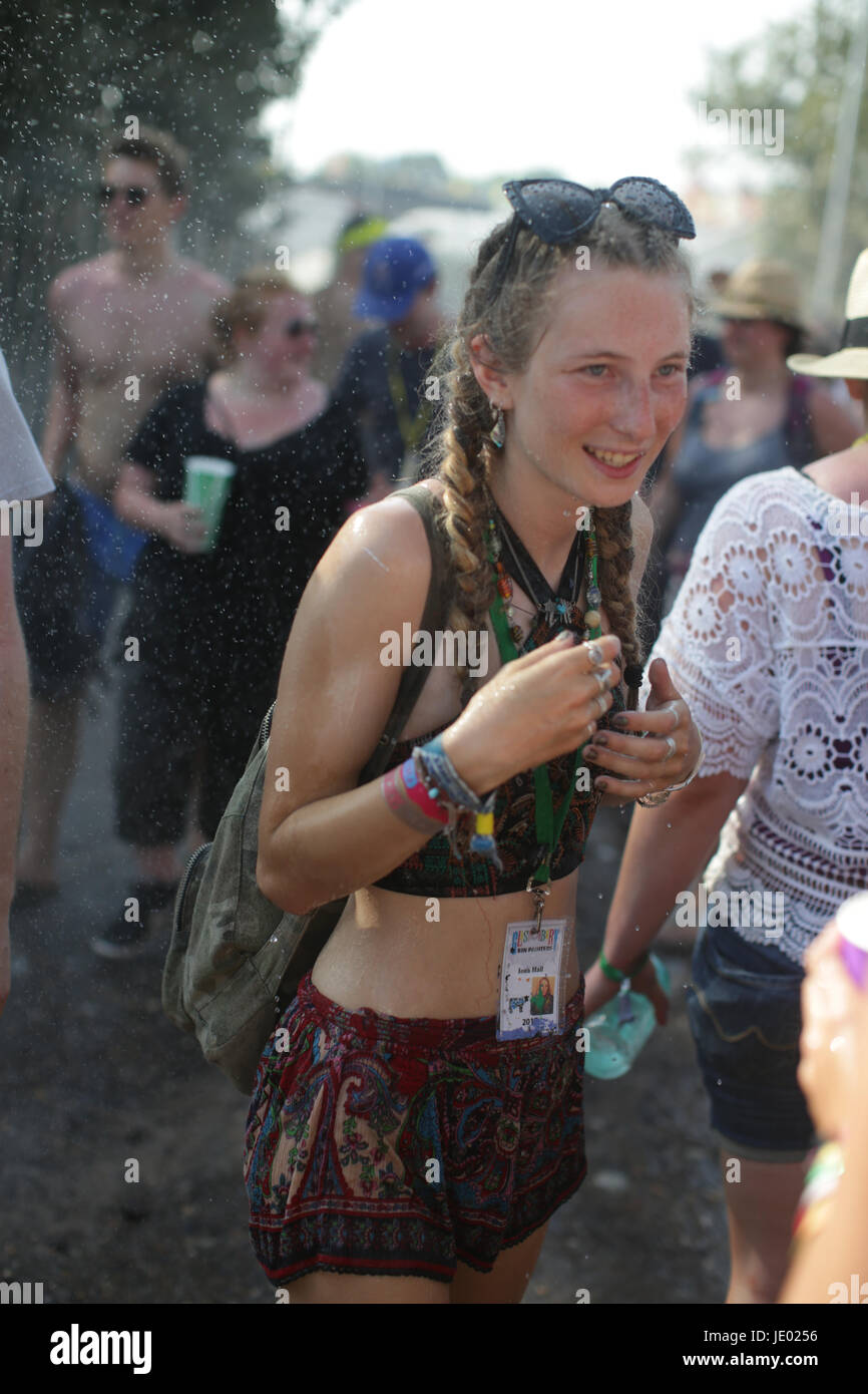 Somerset, UK. 21st June, 2017. A woman is doused by Shepton Mallet firemen on a very hot Day 1 (Wednesday) of the 2017 Glastonbury Festival at Worthy Farm in Somerset. Photo date: Wednesday, June 21, 2017. Credit: Roger Garfield/Alamy Live News Stock Photo