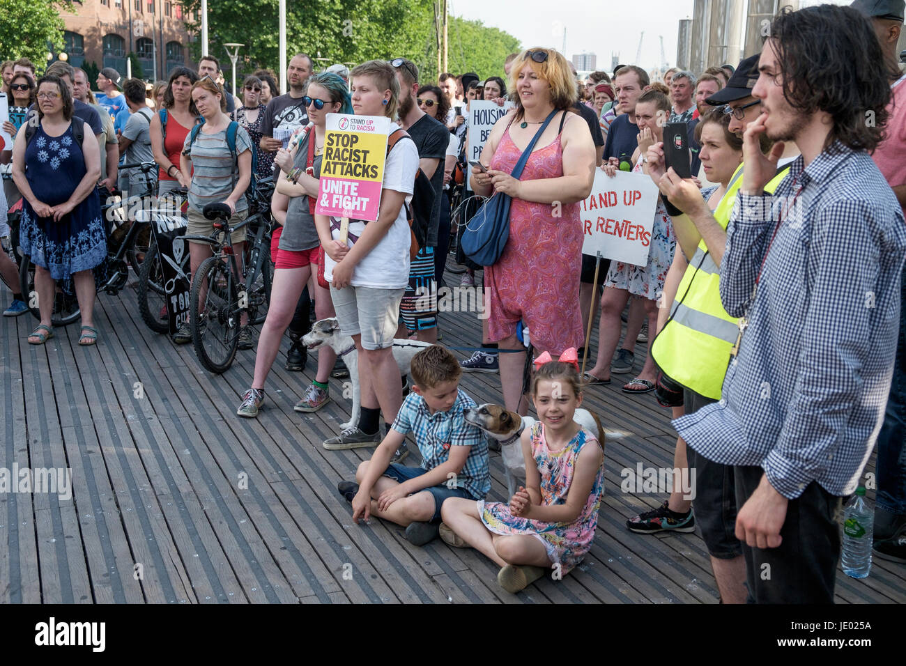 Bristol, UK, 21st June, 2017. Protesters carrying placards are pictured as they listen to speeches before taking part in a Austerity kills, Justice for Grenfell protest march. The demonstration was organised by the Bristol People's Assembly and ACORN community union who say that the protest aims to unite Bristolians in a very visible solidarity with the victims of the Grenfell fire. The organisers deliberately held the protest on the 21st June to coincide with the rescheduled  'Queen's speech' in Parliament. Credit: lynchpics/Alamy Live News Stock Photo