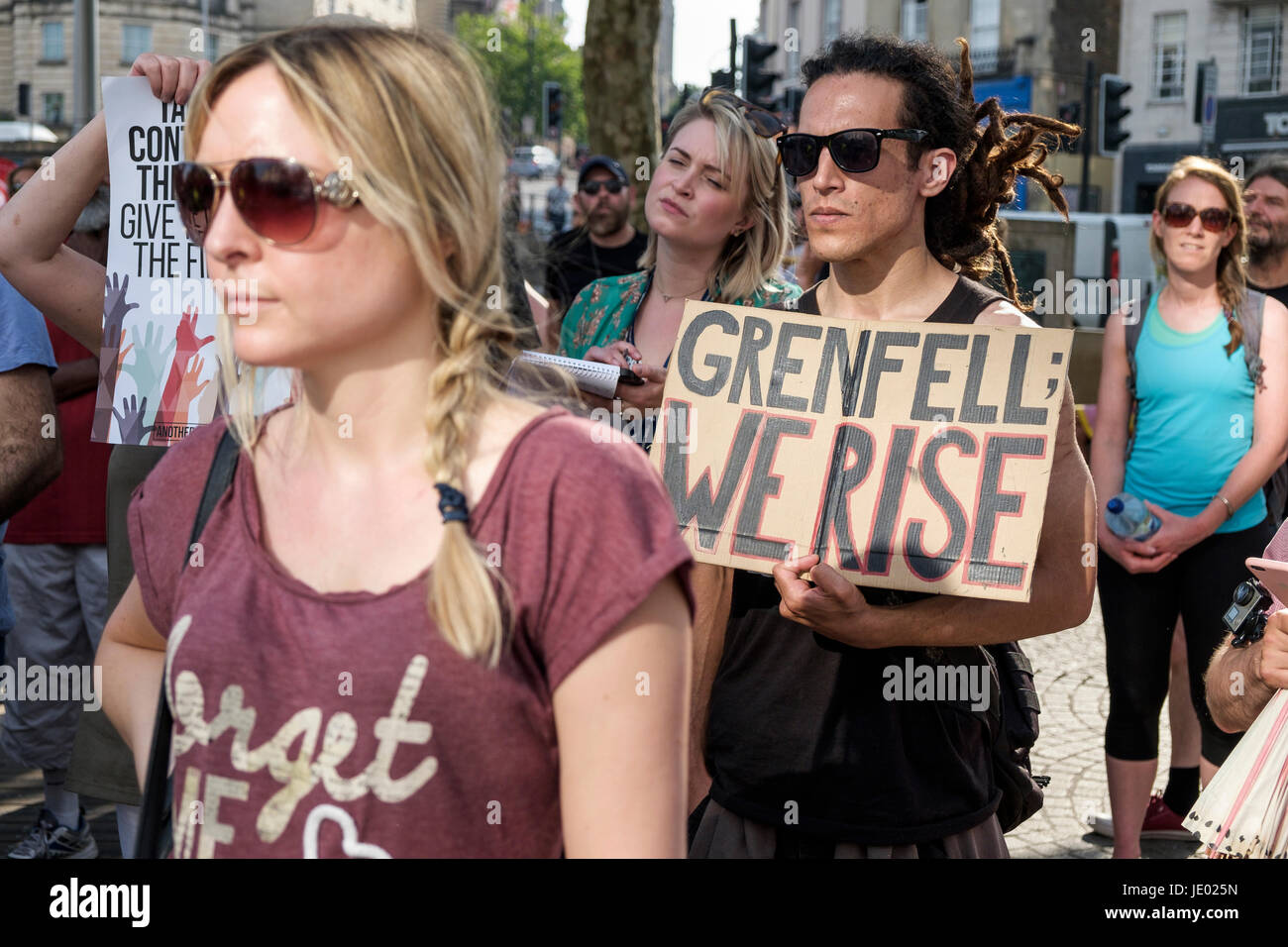 Bristol, UK, 21st June, 2017. Protesters carrying placards are pictured as they take part in a Austerity kills, Justice for Grenfell protest march. The demonstration was organised by the Bristol People's Assembly and ACORN community union who say that the protest aims to unite Bristolians in a very visible solidarity with the victims of the Grenfell fire. The organisers deliberately held the protest on the 21st June to coincide with the rescheduled  'Queen's speech' in Parliament. Credit: lynchpics/Alamy Live News Stock Photo