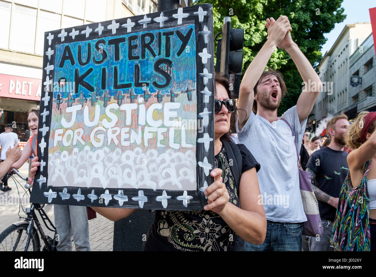 Bristol, UK, 21st June, 2017. Protesters carrying placards are pictured as they take part in a Austerity kills, Justice for Grenfell protest march. The demonstration was organised by the Bristol People's Assembly and ACORN community union who say that the protest aims to unite Bristolians in a very visible solidarity with the victims of the Grenfell fire. The organisers deliberately held the protest on the 21st June to coincide with the rescheduled  'Queen's speech' in Parliament. Credit: lynchpics/Alamy Live News Stock Photo