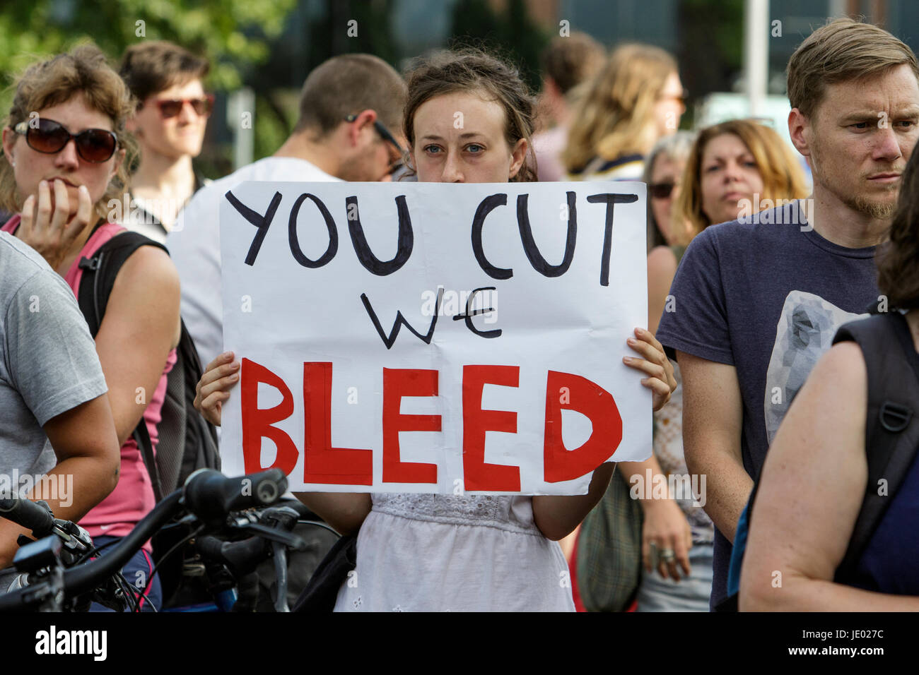 Bristol, UK, 21st June, 2017. Protesters carrying placards are pictured as they listen to speeches before taking part in a Austerity kills, Justice for Grenfell protest march. The demonstration was organised by the Bristol People's Assembly and ACORN community union who say that the protest aims to unite Bristolians in a very visible solidarity with the victims of the Grenfell fire. The organisers deliberately held the protest on the 21st June to coincide with the rescheduled  'Queen's speech' in Parliament. Credit: lynchpics/Alamy Live News Stock Photo