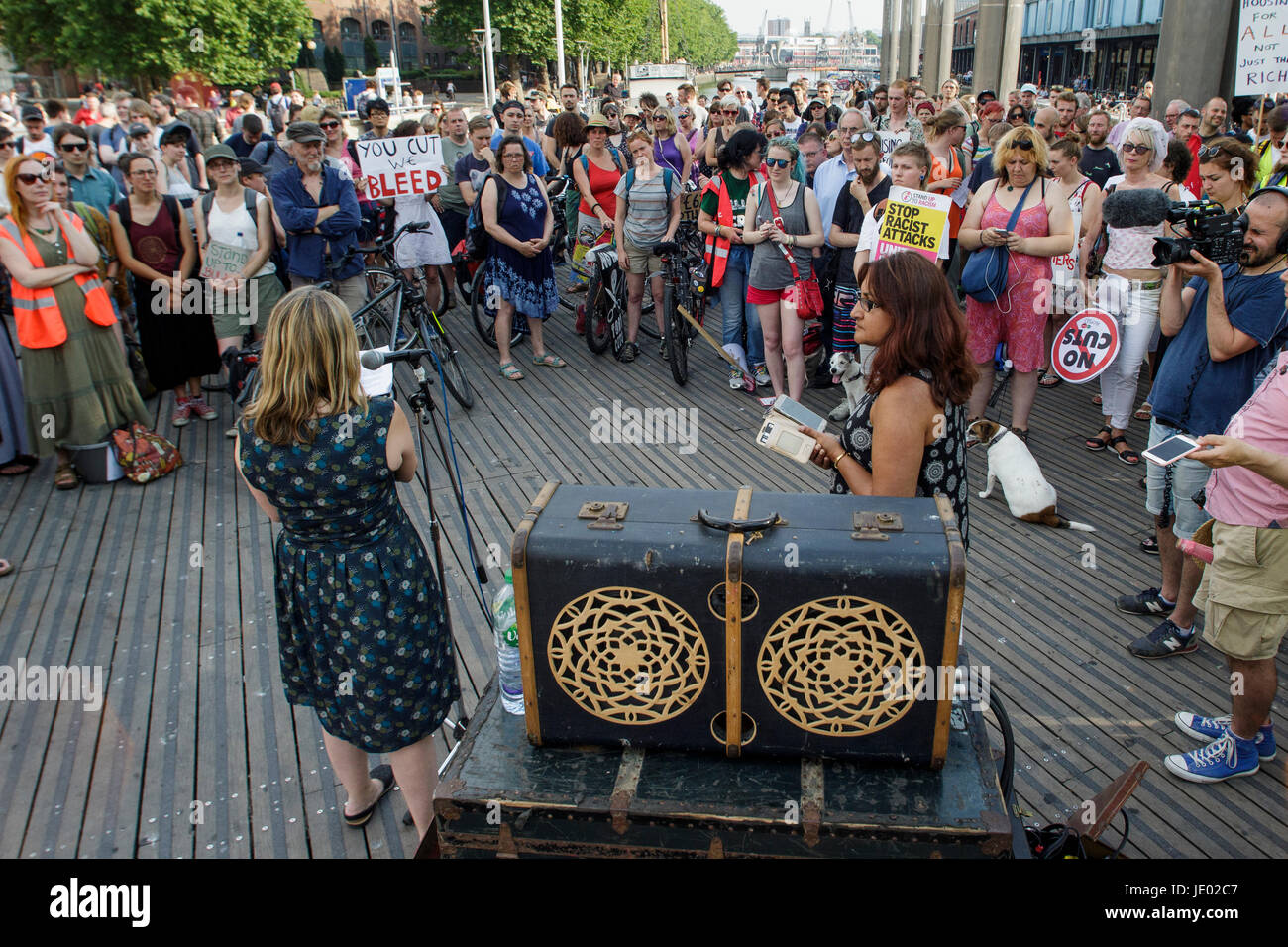 Bristol, UK, 21st June, 2017. Protesters carrying placards are pictured as they listen to speeches before taking part in a Austerity kills, Justice for Grenfell protest march. The demonstration was organised by the Bristol People's Assembly and ACORN community union who say that the protest aims to unite Bristolians in a very visible solidarity with the victims of the Grenfell fire. The organisers deliberately held the protest on the 21st June to coincide with the rescheduled  'Queen's speech' in Parliament. Credit: lynchpics/Alamy Live News Stock Photo