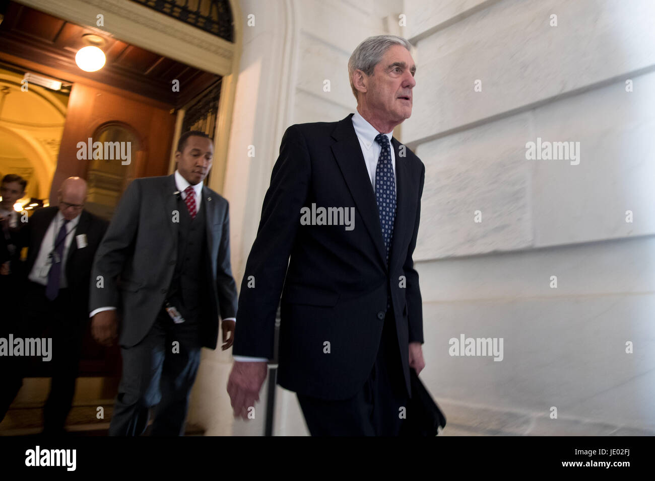 Washington, USA. 21st June, 2017. Former FBI Director Robert Mueller (front), the special counsel probing Russian interference in the 2016 U.S. election, leaves the Capitol building after meeting with the Senate Judiciary Committee on Capitol Hill in Washington, DC, the United States, on June 21, 2017. Credit: Ting Shen/Xinhua/Alamy Live News Stock Photo