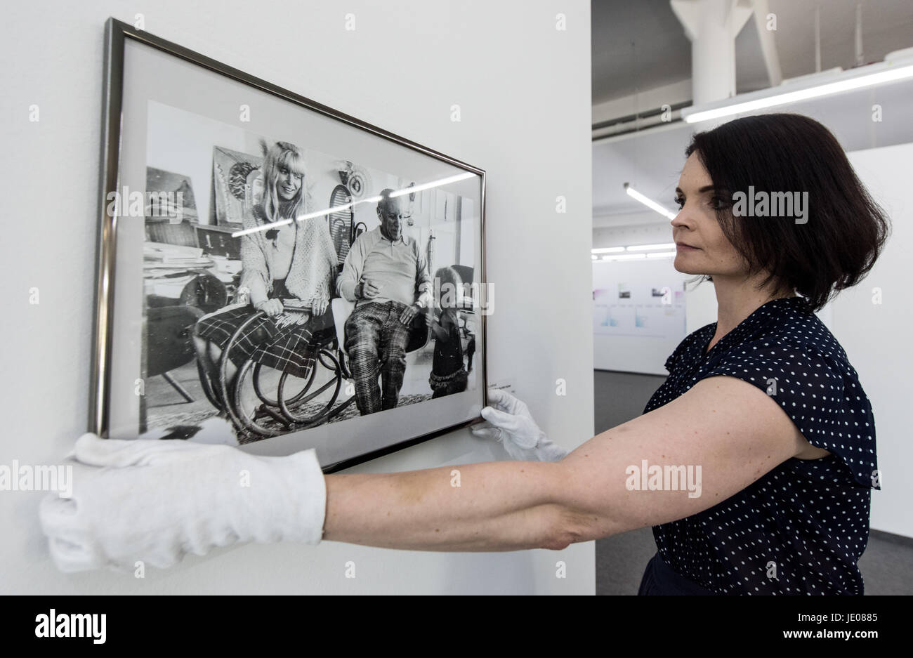 Riegel, Germany. 21st June, 2017. An employee of the art hall places a photograph of Sylvette David with Pablo Picasso on the wall at the exhibition 'Picasso and the Women' at the art hall Messmer in Riegel, Germany, 21 June 2017. The exhibition showcases women in the life of Picasso that served as muses and became artists in their own right. The exhibition can be seen between the 24th of June 2017 and the 12th of November 2017. Photo: Patrick Seeger/dpa/Alamy Live News Stock Photo