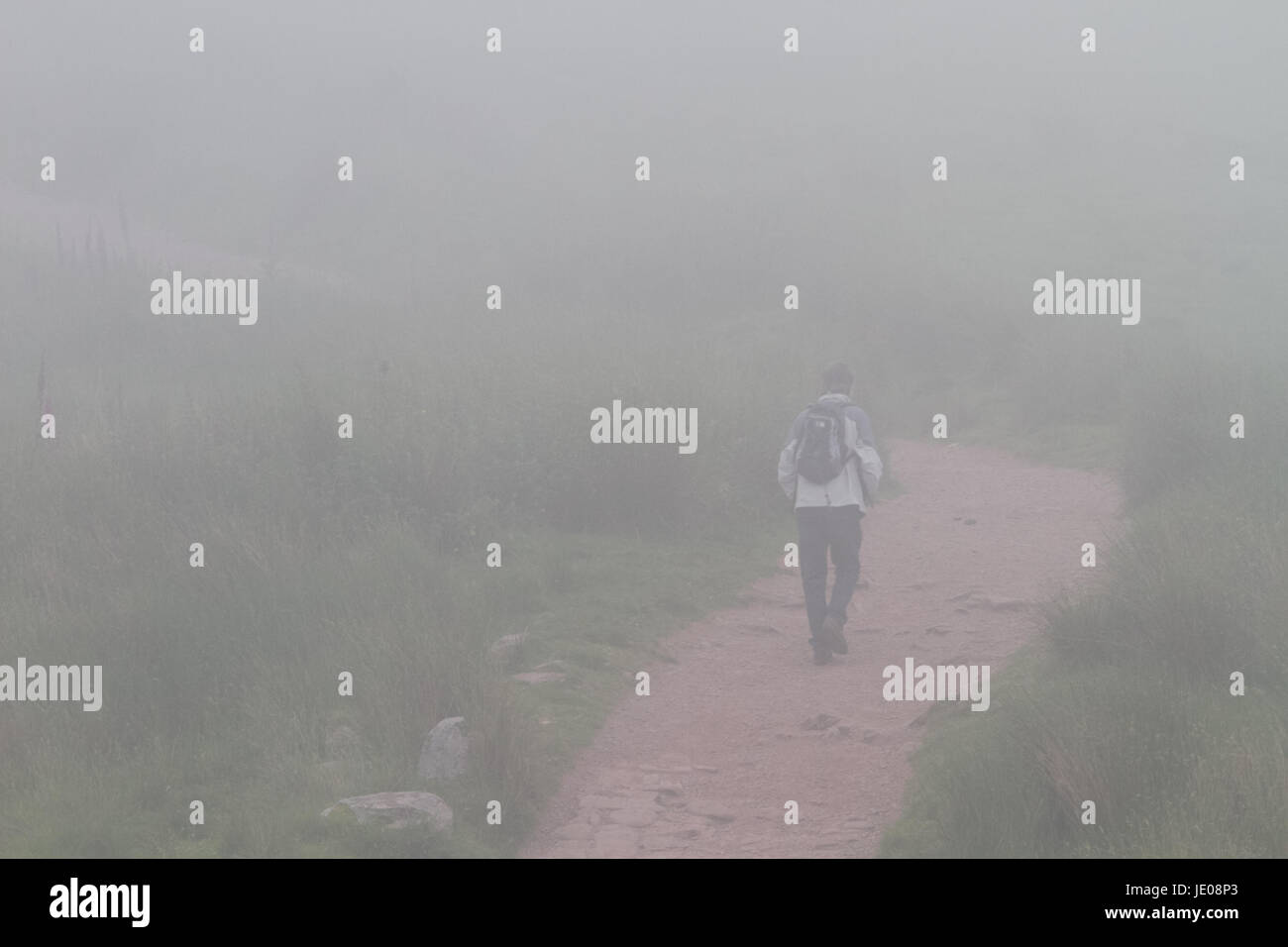 Pont-Yr Daf, Brecon Beacons, South Wales. 22 June 2017.  UK weather: Ramblers climb the ascent to Pen-Y-Fan today in severe fog, as the warm weather comes to an end.  Credit: Andrew Bartlett/Alamy Live News Stock Photo