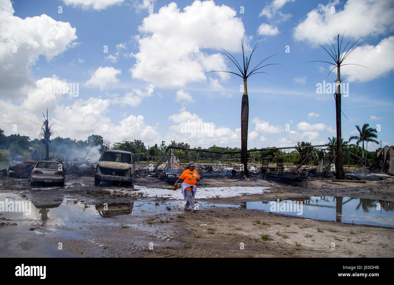 Delray Beach, Florida, USA. 22nd June, 2017. A fire destroyed a wood packing house leased by Otero Nurseries Thursday morning. Two vehicles and two trailers were also destroyed by the fire in Delray Beach, Florida on June 22, 2017. Rosita Caudillo, who works for Otero Nurseries lost her drivers license and social security card and key fob to another car in the fire. The car was not insured as she was getting ready to sell it. The fire was possibly was caused by a torch being used to dismantle some green houses. Credit: Allen Eyestone/The Palm Beach Post/ZUMA Wire/Alamy Live News Stock Photo