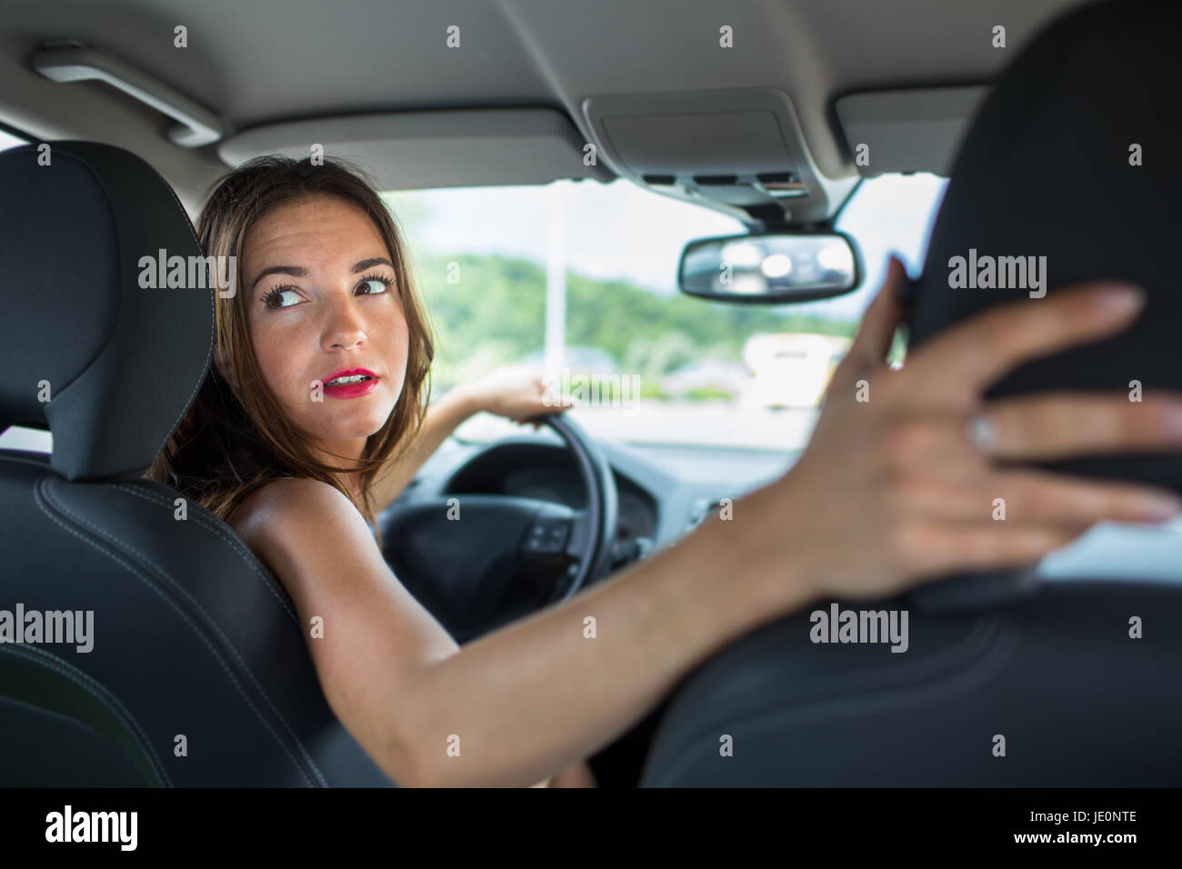 Young, woman driving a car, going home from work Stock Photo Alamy