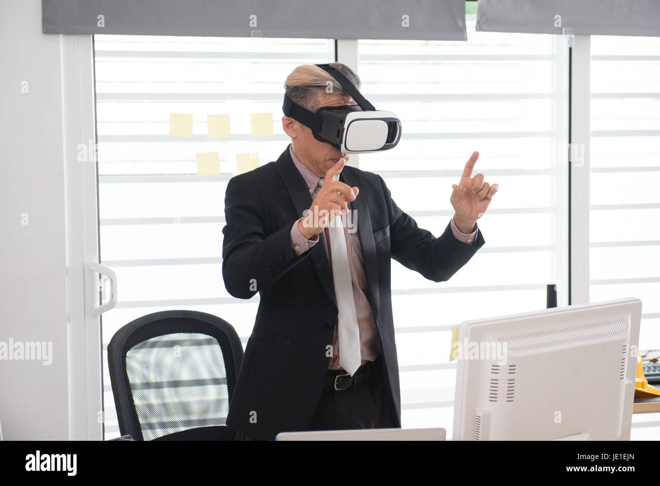 Businessman making gestures when wearing virtual reality goggles Stock ...