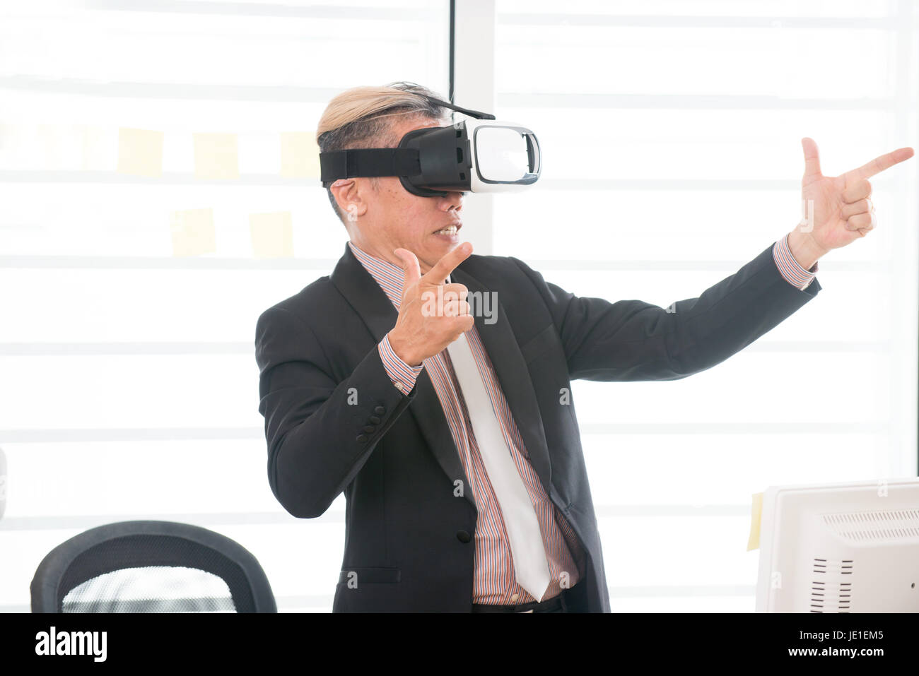 Businessman making gestures when wearing virtual reality goggles Stock ...