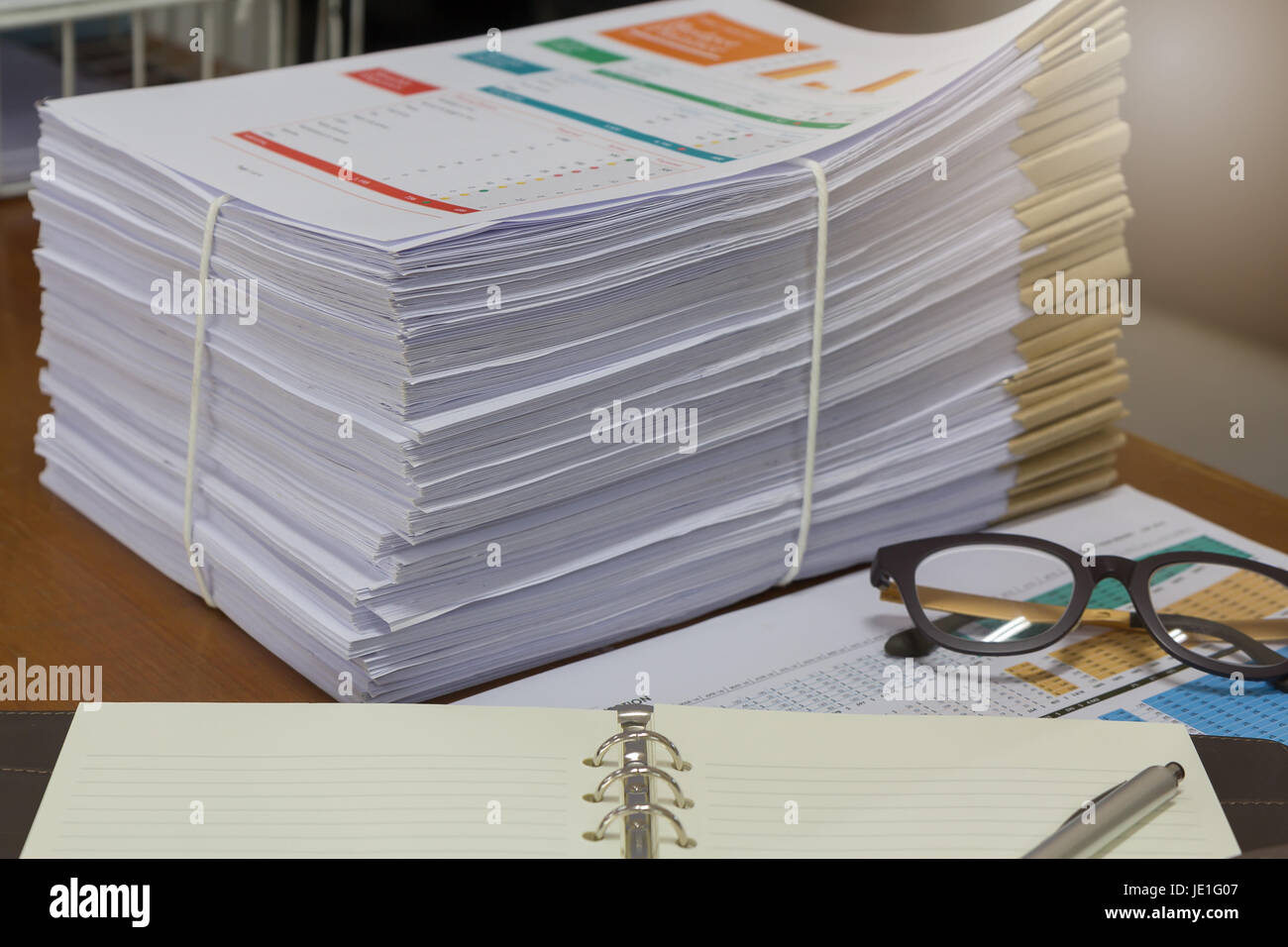 Pile of unfinished documents on office desk, Stack of business paper Stock Photo