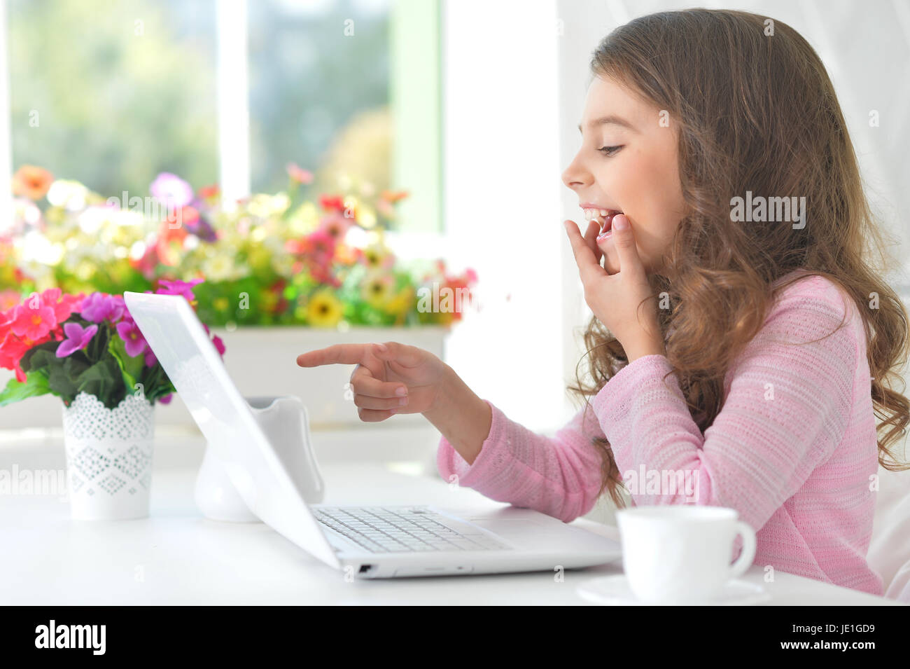 Portrait of adorable little girl using modern laptop Stock Photo - Alamy