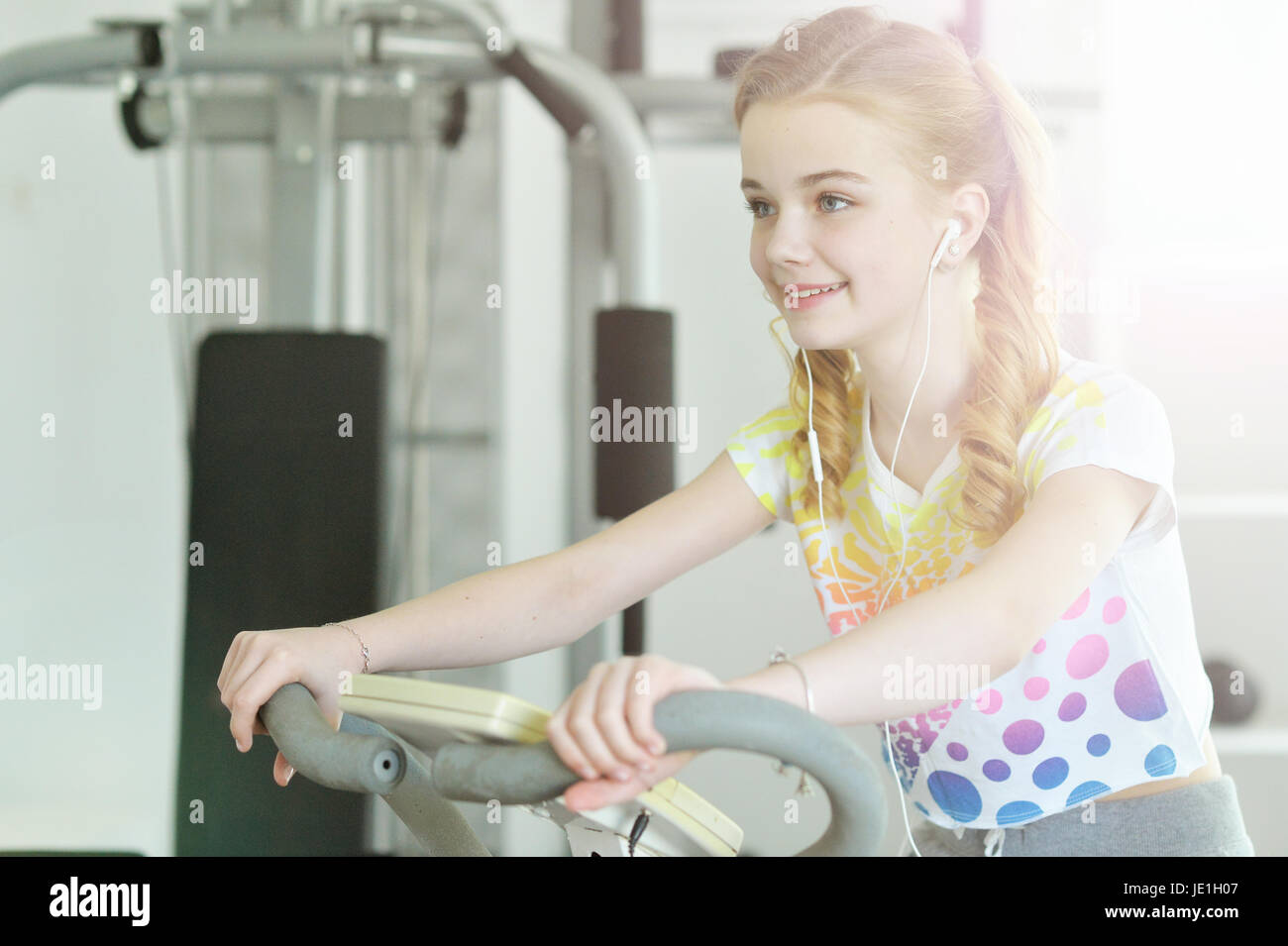 Cute little girl doing exercises on treadmill Stock Photo - Alamy