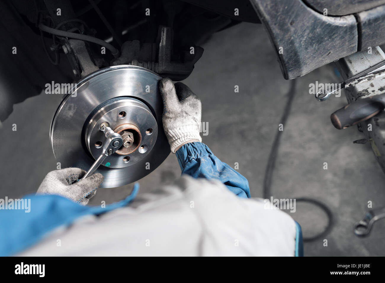 Car mechanic hands replace brakes in garage Stock Photo Alamy