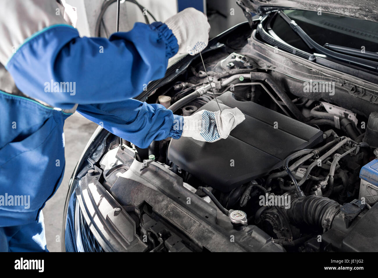 Mechanic checking oil level in a car Stock Photo Alamy