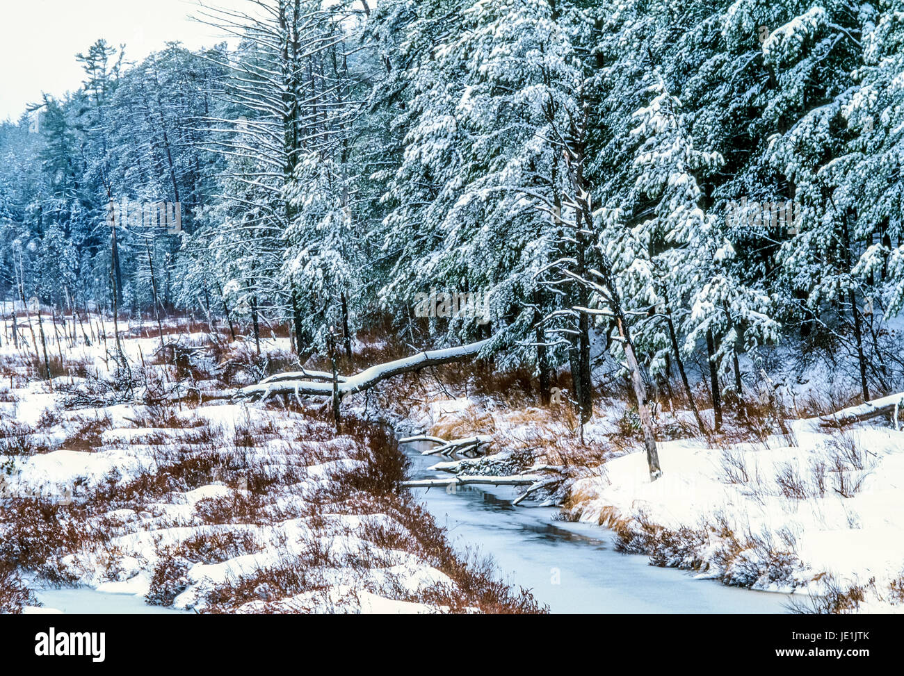 White Mountains, New Hampshire in winter with stream and countryside ...