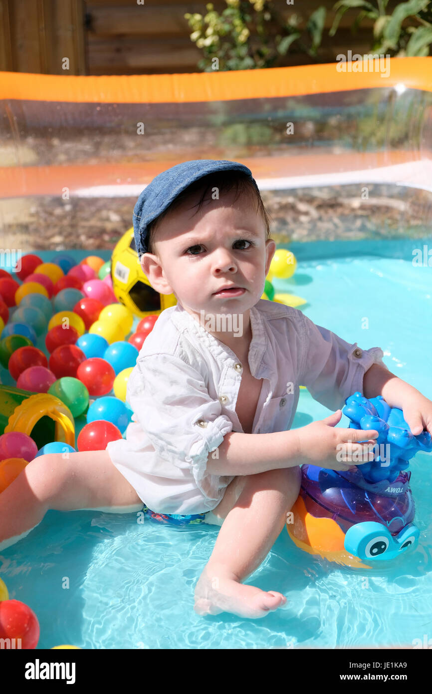 baby boy in paddling pool on sunny day Stock Photo Alamy