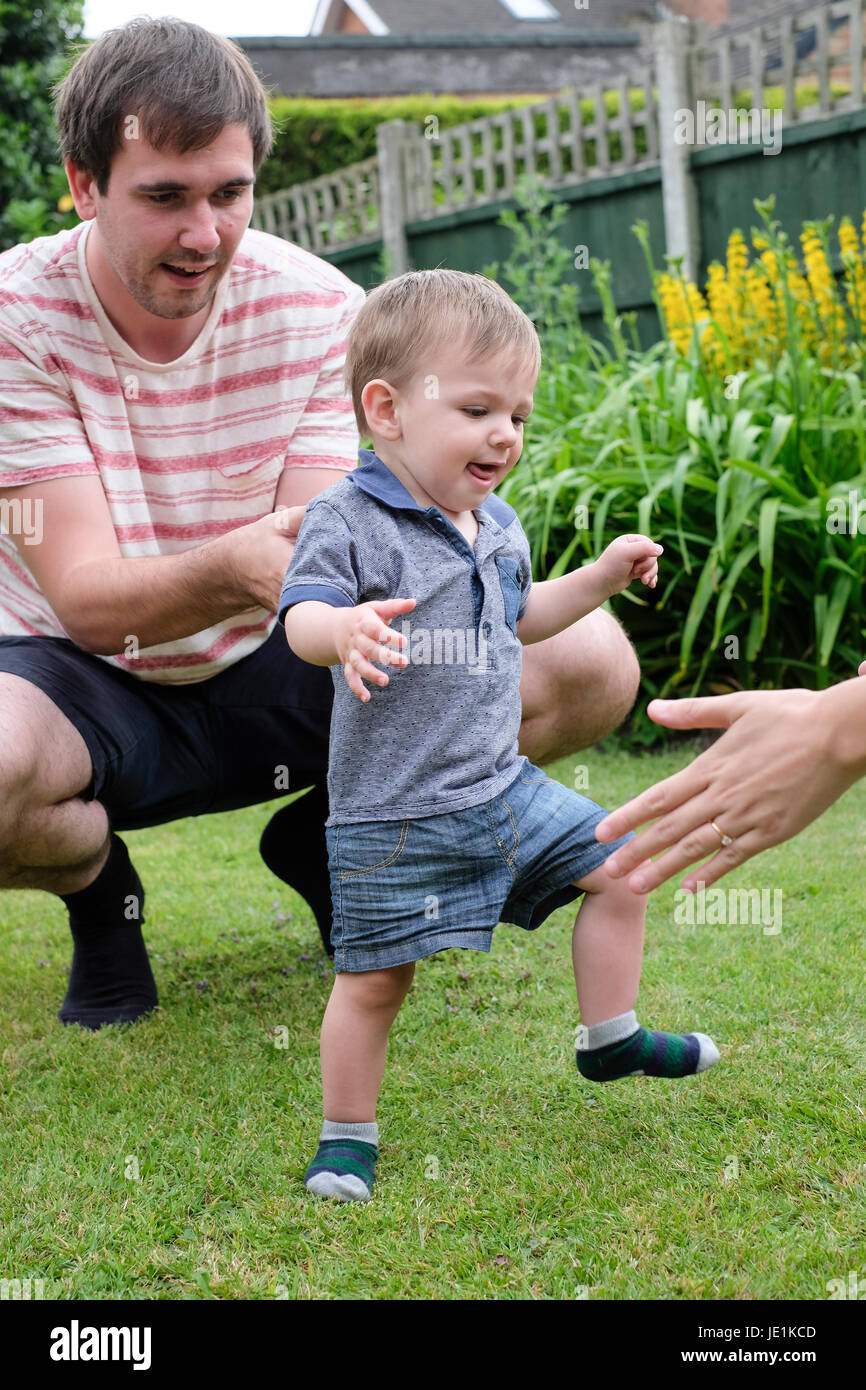 One year old baby boy taking first steps Stock Photo