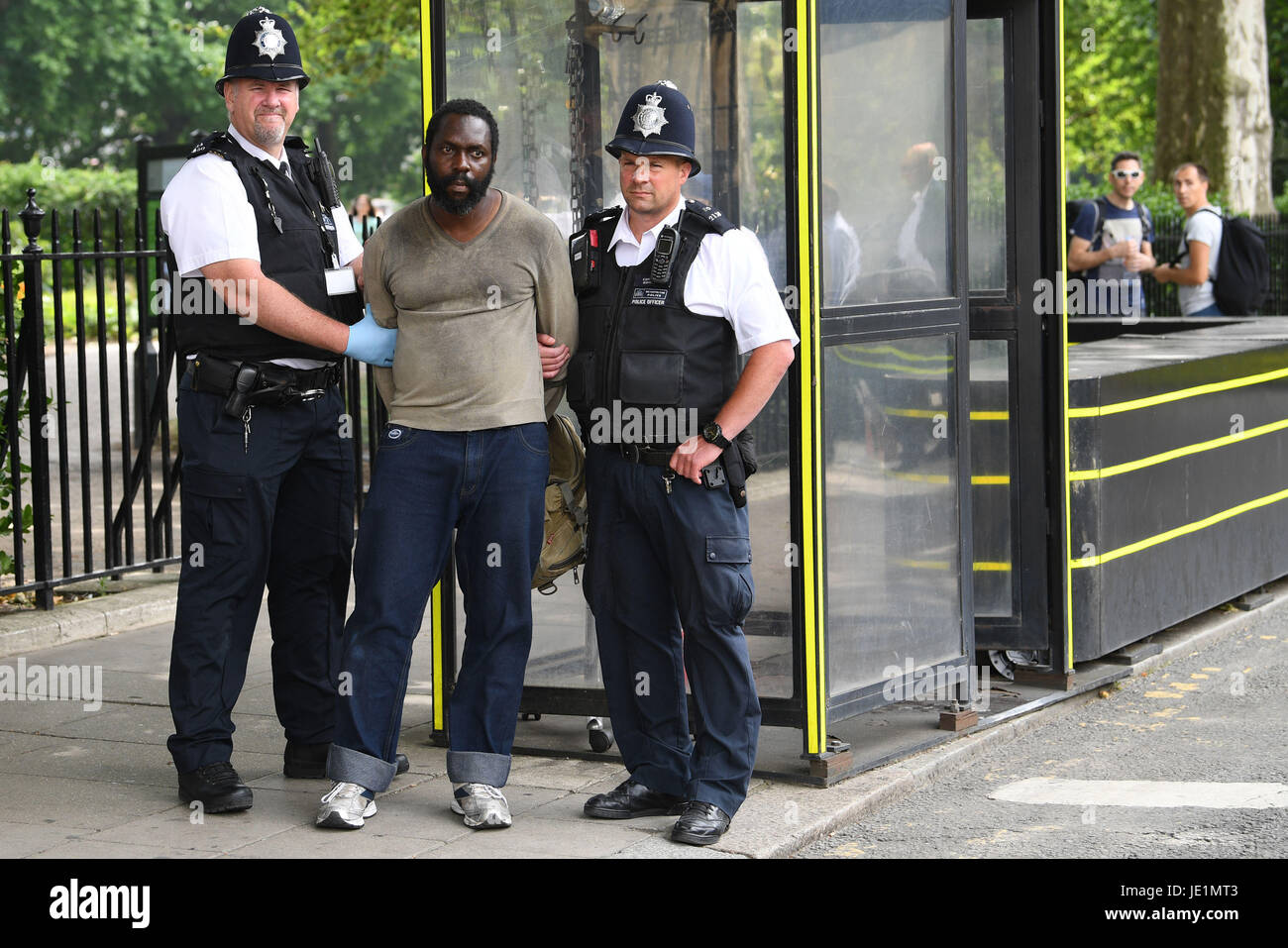 A man is led away by police outside the Houses of Parliament in London ...