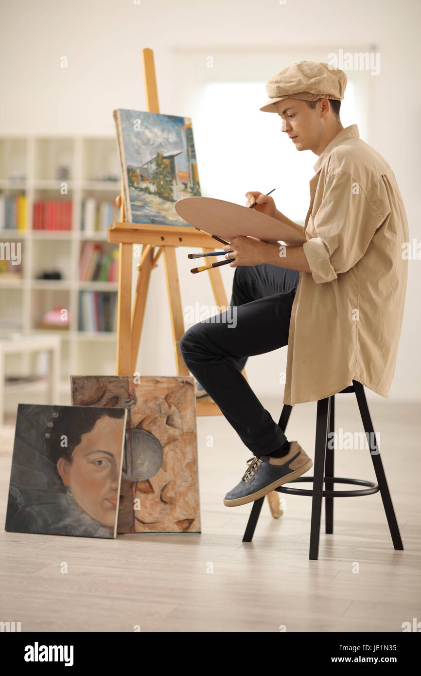 Teenage painter painting on a canvas in an art studio Stock Photo