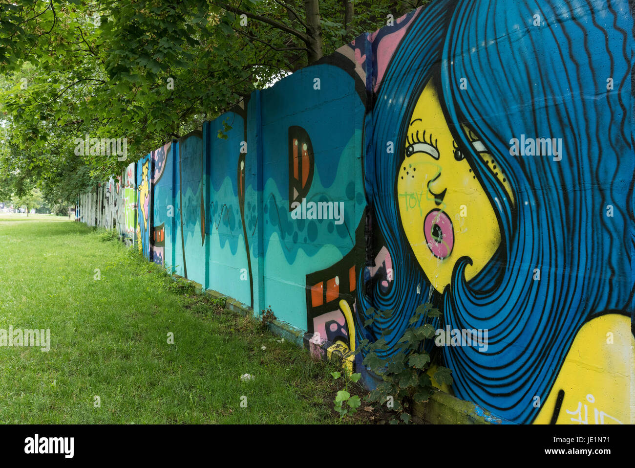 Berlin. Germany. Remaining section of the Berlin Wall with graffiti at Puschkinallee, listed as a historical monument since 2005. Stock Photo